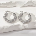 Close-up of silver hoop earrings with twisted metal and shimmering cubic zirconia - Silver White Zirconia (E1203)