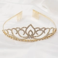 Close-up detail of golden bridal tiara with sparkling rhinestones on white silk - Gold White Zirconia
