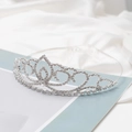 Elegant silver bridal tiara with sparkling crystal hearts on silky white satin background - Silver White Rhinestone