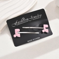 Pair of stylish pink oil-dripping musical note hair clips on elegant display card - Pink