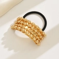 U-shaped hair tie with golden metal beads and black elastic band for sleek pony tails - Gold