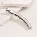Sleek silver metal banana hair clip with teeth on a minimalist stone background - Silver