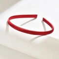 Minimalist deep red satin wrapped hairband 1cm wide on a modern white artistic display - Red