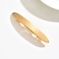 Macro detail of glossy golden metal hair clip with a smooth mirror finish on white background - Marquise / Gold