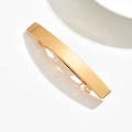 Close-up of a minimalist gold metal spring hair clip with a polished finish on a white surface - Square / Gold