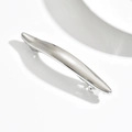 Macro shot of polished silver metal hair clip with a sleek curved spring design - Wave / Silver