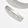 Detail shot of the sleek brushed silver finish on a long metallic spring hair clip - Square / Silver