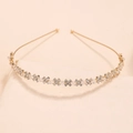 Detailed macro view of golden bridal headband with crystals and X-shaped rhinestones - Cross Gold