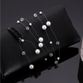 Pince à cheveux élégante avec perles et longs glands sur fil invisible pour femmes - Style Perle et Perle Claire