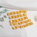 Detailed view of hollow gold metal hair cuffs and engraved rings for dreadlocks - Gold
