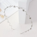 Elegant silver wavy headband with sparkling rhinestones for a minimalist bridal look - Silver