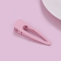 Detail view of pink matte duckbill hair clip with anti-slip teeth and metal spring - Pink