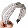 Detail of grey ribbed knit headband featuring a central knot and protective black ends - Light Gray