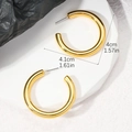 Detail view of 4cm polished golden C-shaped hoop earrings on a stone base display - Gold (4CM)