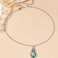 Bohemian style necklace with turquoise oval pendant and intricate silver flower detailing - Necklace