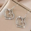 Detailed view of silver heart earrings with sparkling rhinestones on champagne gift box - Silver Earrings (D3223)