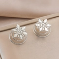 Macro detail of silver snowflake earring with three-tier spiral base and hollow design - Silver