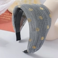 Close-up of wide headband with grey pleated fabric and golden polka dot patterns - Gray