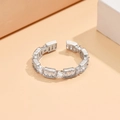 Detailed view of silver copper ring featuring baguette and square cubic zirconia stones - Silver