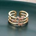 Macro shot of gold layered ring with pink zircon butterflies on a dark green surface - Three Layer Butterfly Open Style / Gold Style (D8427)