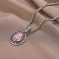 Vintage pink gemstone necklace with silver filigree on elegant brown pleated fabric - Silver