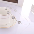 Detail of silver floral headband with rhinestones and pearls on white coffee cup - Silver