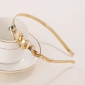 Cerchietto serpente in metallo dorato con occhi di pietre verdi su sfondo ceramica - Stile Oro (C9214)