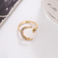 Close-up of gold moon and star ring with micro-pave rhinestones in a lifestyle setting - Star Moon Shape (D9113) / Gold
