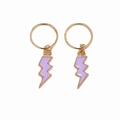 Detail view of golden hair rings featuring purple lightning bolt pendants for braids - Purple Lightning Pair