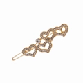Detalle de pasador dorado con cuatro corazones incrustados de strass brillantes - Dorado