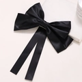 Detail of the large black satin bow hair clip with long ribbons and metal spring fastener - Black