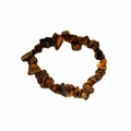 Macro shot of polished tiger eye stone beads on a stretch bracelet with golden brown sheen - Amber