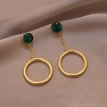 Elegant gold drop earrings with dark green stones and large hoops on brown satin fabric - Gold