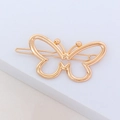 Close-up of a minimalist hollow gold butterfly hair clip on a geometric surface - Butterfly Design / Gold