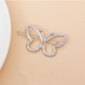 Detailed close-up of a silver butterfly-shaped metal hair clip with a sleek hollow design - Butterfly Design / Silver
