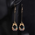 Long gold bow earrings with colorful rhinestones on a black background model - Multicolor Dangle Earrings (A6102)