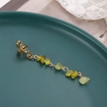 Detailed macro view of vintage gold alloy ear cuff with light green stone tassel - Grass Green Short (E9332)
