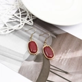 Vintage gold drop earrings featuring oval red resin stones and elegant hook fasteners - Burgundy