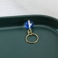 Detail of gold dreadlock bead featuring a blue translucent stone with white swirls - Light Blue (F1425-1#)