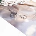 Close-up of silver lightning bolt cutout rings set on a decorative textured background - Lightning Silver (D2423)