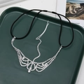 Detailed view of gothic rhinestone forehead chain with cascading crystal tassels on green tray - Curved Crown Fringe Style (D2422)