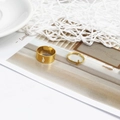 Close-up of gold adjustable couple rings set with lightning bolt cutout and charm detail - Lightning Gold (D2424)
