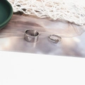 Close-up of minimalist couple heart rings with adjustable open band in silver finish - Heart Silver (D2425)