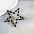 Elegante fermaglio per capelli a stella dorata con perline nere su fondo azzurro - Nero
