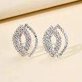 Macro detail of geometric leaf-shaped silver earrings with sparkling pavé crystals - Silver