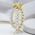 Elegante pinza per capelli in metallo dorato con perle bianche per acconciature a coda - Oro