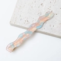 Macro detail of wave-shaped acetate hair clip with pink and blue marble texture - Pink and Light Blue Interwoven Marble (E3226-7#)