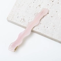 Detailed view of a wave-shaped pink acetate hair clip with pearlescent finish on stone - Iridescent Pearl Luster Pink (E3225-9#)