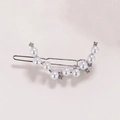 Close-up of silver hair clip with elegant pearls and sparkling rhinestones on grey background - Silver