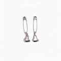 Macro shot of silver gothic safety pin earrings featuring minimalist hollow heart charms - Heart Shape